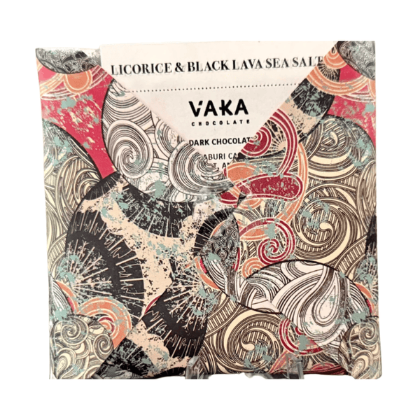 Vaka Chocolate licorice & black lava sea salt dark chocolate bar wrapped in a highly patterned paper sleeve featuring black, red, teal, and beige swirls, on a white background.