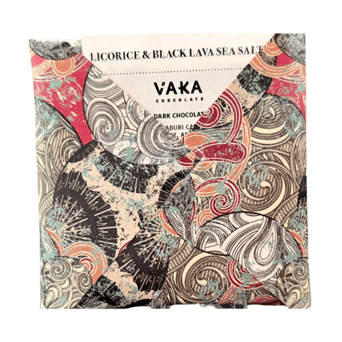 Vaka Chocolate licorice & black lava sea salt dark chocolate bar wrapped in a highly patterned paper sleeve featuring black, red, teal, and beige swirls, on a white background.